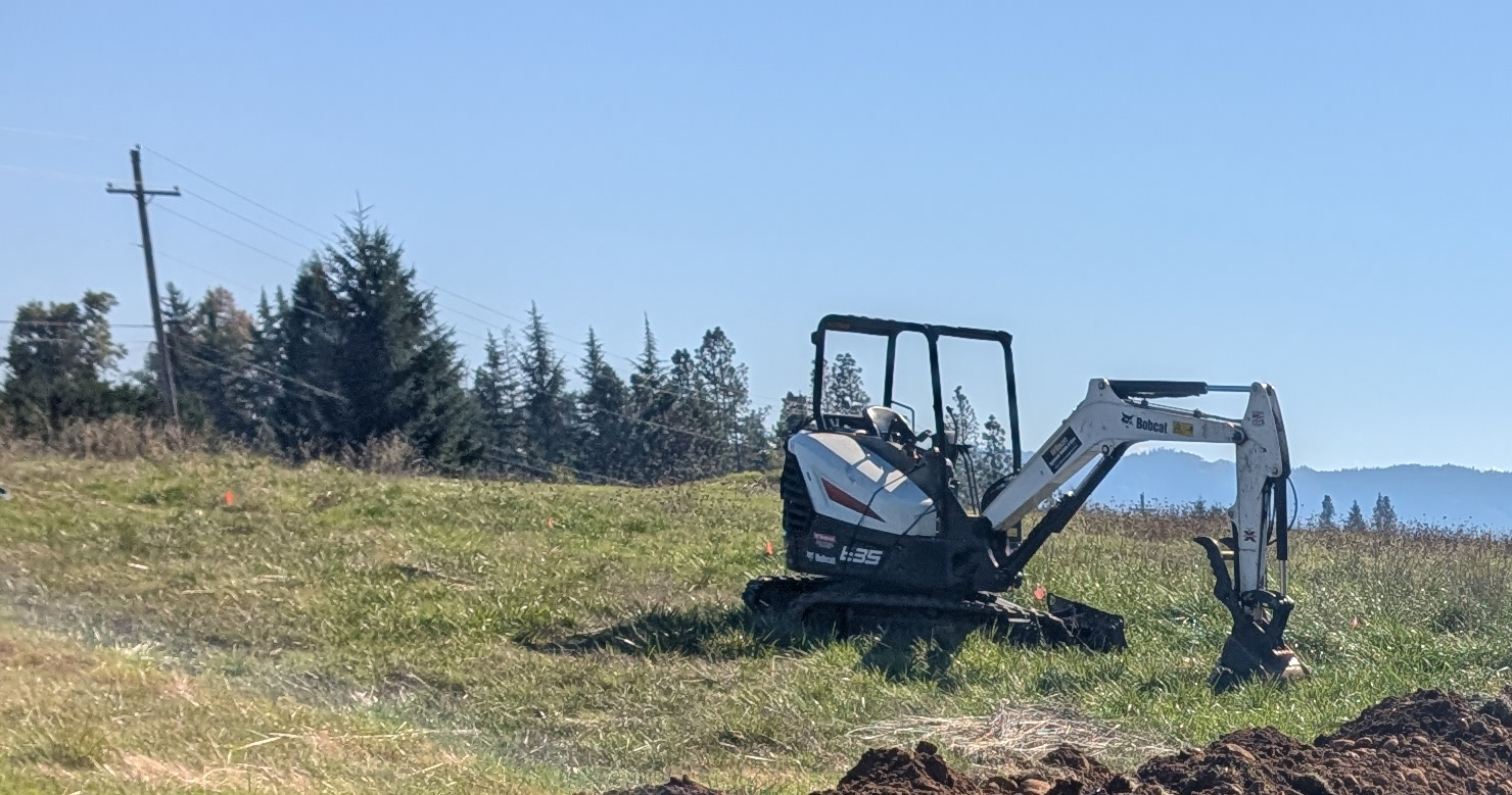 Excavator working on drain field on a Douglas County property